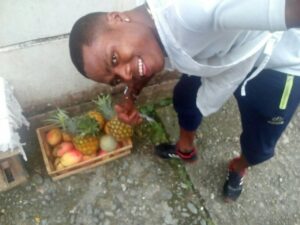 A picture of one of the victims, Wilber Mina Lizalda, pointing to a basket of fruit
